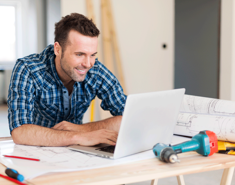 Person smiling and using laptop