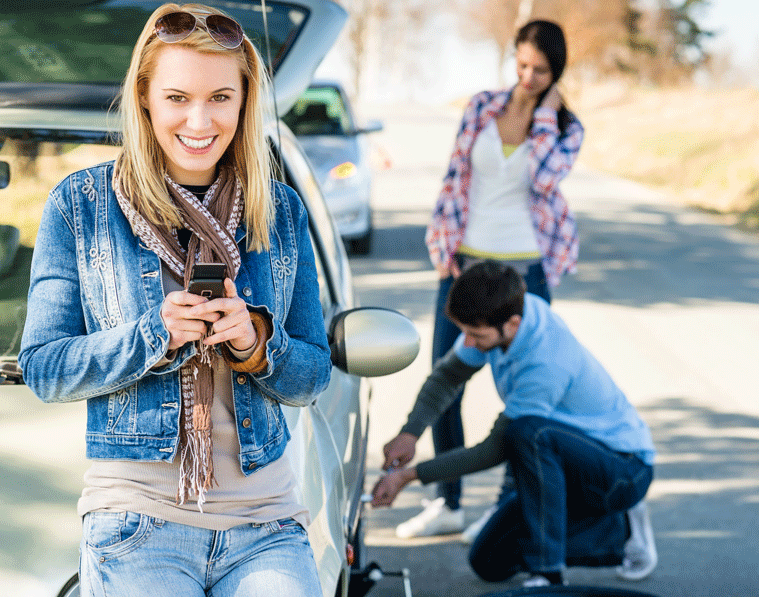 People changing tire on car